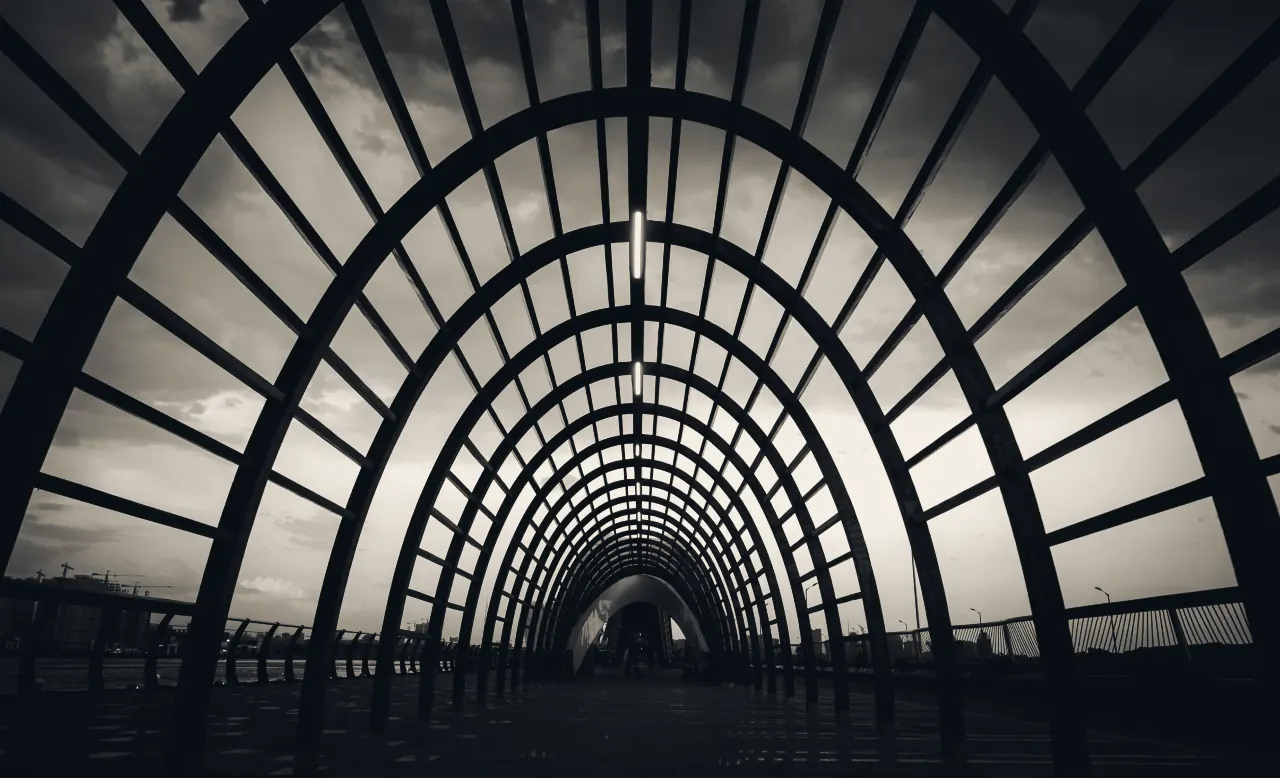 A long walkway under a series of steel arches