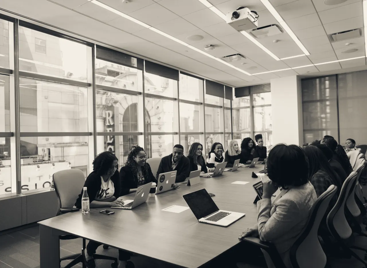 A team gathered around a long boardroom table